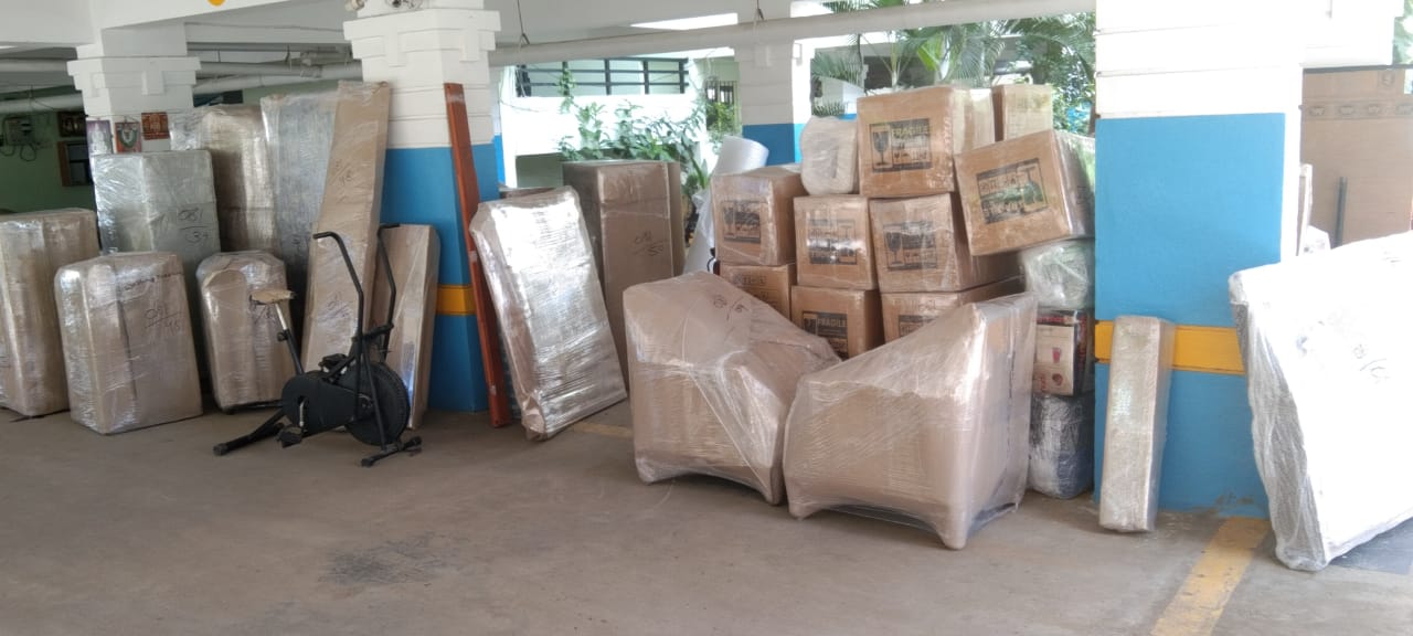 Moving team loading boxes into transport vehicle